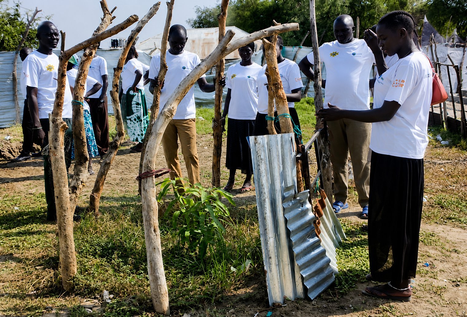 ORBIT team and community members building a sanitation structure